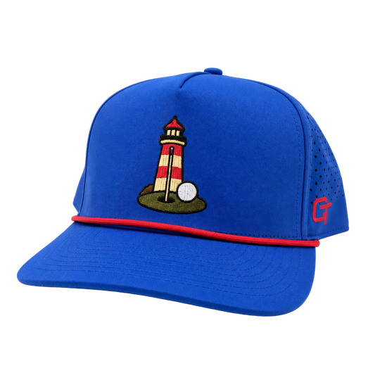 A royal blue baseball cap with a red brim stripe, featuring an embroidered lighthouse and golf ball on the front, and a red 'CT' logo on the side mesh.