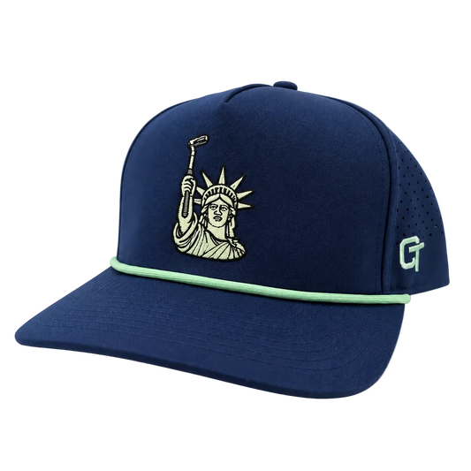 A navy blue baseball cap featuring an embroidered Statue of Liberty design on the front, a mint green accent stripe across the visor, and a mint green 'CT' logo on the side, set against a plain white background.